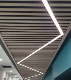 Acoustic Ceiling with Lighting - Slatted Oak over Black Fabric with Acoustic Insulation Behind - Zig Zag Light (2) Cut